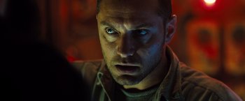 Movie still from “Black Sea” (2014), directed by Kevin Macdonald – A person staring at the camera; Close Up shot, Low angle
