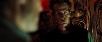 Movie still from “Black Sea” (2014), directed by Kevin Macdonald – A person in a dark room; Close Up shot, Over the shoulder angle