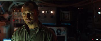 Movie still from “Black Sea” (2014), directed by Kevin Macdonald – A person in a dark room; Close Up shot, Low angle