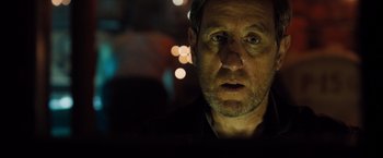 Movie still from “Black Sea” (2014), directed by Kevin Macdonald – A person looking at the camera; Close Up shot, Over the shoulder angle