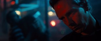 Movie still from “Black Sea” (2014), directed by Kevin Macdonald – A person's face in the dark; Close Up shot, Over the shoulder angle