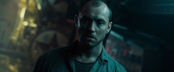 Movie still from “Black Sea” (2014), directed by Kevin Macdonald – A person wearing a green shirt; Close Up shot, Low angle