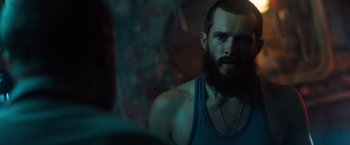Movie still from “Black Sea” (2014), directed by Kevin Macdonald – A man with a beard is looking into a mirror; Close Up shot, Over the shoulder angle