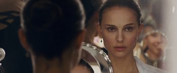 Movie still from “Black Swan” (2010), directed by Darren Aronofsky – A person looking at a mirror; Close Up shot, Over the shoulder angle