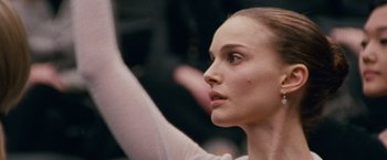 Movie still from “Black Swan” (2010), directed by Darren Aronofsky – A person with her hand raised up; Close Up shot, Low angle