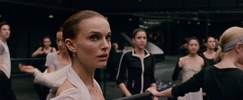 Movie still from “Black Swan” (2010), directed by Darren Aronofsky – A woman standing next to another woman in front of a piano; Close Up shot, Over the shoulder angle