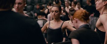 Movie still from “Black Swan” (2010), directed by Darren Aronofsky – A woman standing in front of a crowd; Medium shot, Over the shoulder angle