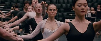 Movie still from “Black Swan” (2010), directed by Darren Aronofsky – A group of people are practicing a dance move; Medium shot, Over the shoulder angle