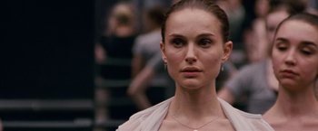 Movie still from “Black Swan” (2010), directed by Darren Aronofsky – A person wearing a white shirt; Close Up shot, Over the shoulder angle