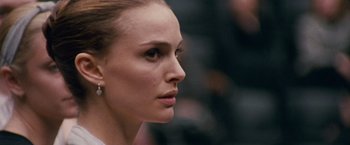 Movie still from “Black Swan” (2010), directed by Darren Aronofsky – A woman's face in a white shirt; Close Up shot, Over the shoulder angle
