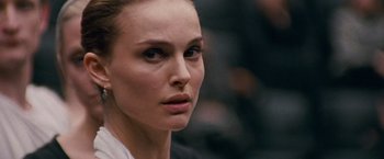 Movie still from “Black Swan” (2010), directed by Darren Aronofsky – A woman's face in a dark room; Close Up shot, Over the shoulder angle