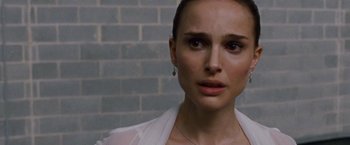Movie still from “Black Swan” (2010), directed by Darren Aronofsky – A person wearing a white shirt; Close Up shot, Over the shoulder angle