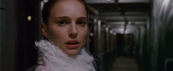 Movie still from “Black Swan” (2010), directed by Darren Aronofsky – A person wearing a white scarf; Close Up shot, Over the shoulder angle
