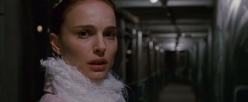 Movie still from “Black Swan” (2010), directed by Darren Aronofsky – A person wearing a white dress; Close Up shot, Over the shoulder angle