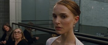 Movie still from “Black Swan” (2010), directed by Darren Aronofsky – A person wearing a white shirt; Close Up shot, Over the shoulder angle