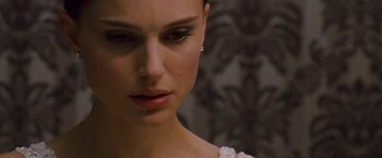 Movie still from “Black Swan” (2010), directed by Darren Aronofsky – A woman's face in a white dress; Close Up shot, Over the shoulder angle