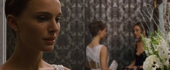 Movie still from “Black Swan” (2010), directed by Darren Aronofsky – A woman in a white dress standing in front of a mirror; Close Up shot, Over the shoulder angle
