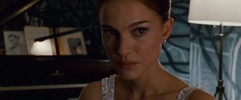Movie still from “Black Swan” (2010), directed by Darren Aronofsky – A person wearing a dress; Close Up shot, Over the shoulder angle
