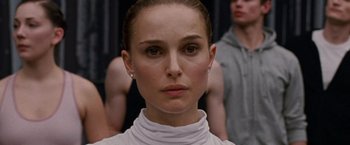 Movie still from “Black Swan” (2010), directed by Darren Aronofsky – A person wearing a white shirt; Close Up shot, Low angle