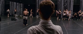 Movie still from “Black Swan” (2010), directed by Darren Aronofsky – A group of people are practicing a dance move; Medium shot, Over the shoulder angle