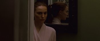 Movie still from “Black Swan” (2010), directed by Darren Aronofsky – A woman standing in front of a bathroom mirror; Close Up shot, Over the shoulder angle