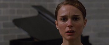 Movie still from “Black Swan” (2010), directed by Darren Aronofsky – A person wearing a dress; Close Up shot, Over the shoulder angle