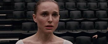 Movie still from “Black Swan” (2010), directed by Darren Aronofsky – A person wearing a white shirt; Close Up shot, Over the shoulder angle