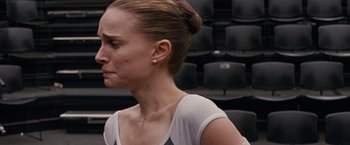 Movie still from “Black Swan” (2010), directed by Darren Aronofsky – A person wearing a white shirt; Close Up shot, Over the shoulder angle