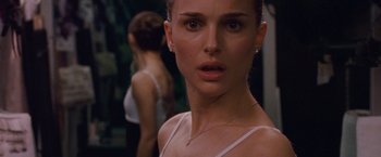 Movie still from “Black Swan” (2010), directed by Darren Aronofsky – A person wearing a white shirt; Close Up shot, Over the shoulder angle