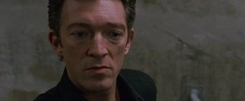 Movie still from “Black Swan” (2010), directed by Darren Aronofsky – A man's face in a black shirt; Close Up shot, High angle