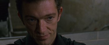 Movie still from “Black Swan” (2010), directed by Darren Aronofsky – A man's face in a dark room; Close Up shot, Over the shoulder angle