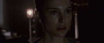 Movie still from “Black Swan” (2010), directed by Darren Aronofsky – A person wearing a ear piece; Close Up shot, Over the shoulder angle