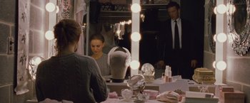 Movie still from “Black Swan” (2010), directed by Darren Aronofsky – A woman sitting in front of a mirror in a dressing room; Medium shot, Over the shoulder angle