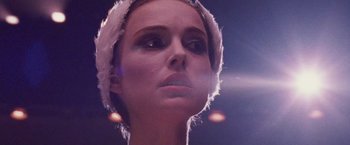 Movie still from “Black Swan” (2010), directed by Darren Aronofsky – A person wearing a white hat; Close Up shot, Low angle