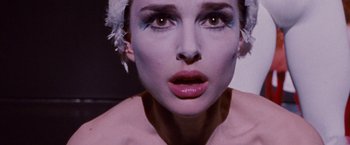 Movie still from “Black Swan” (2010), directed by Darren Aronofsky – A person wearing makeup with feathers; Close Up shot, Overhead angle