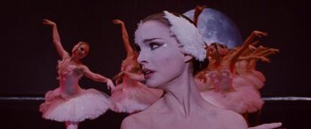 Movie still from “Black Swan” (2010), directed by Darren Aronofsky – A person wearing a swan costume; Close Up shot, Over the shoulder angle
