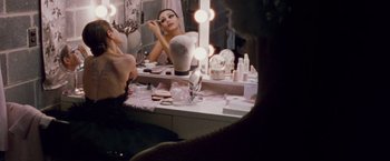 Movie still from “Black Swan” (2010), directed by Darren Aronofsky – A woman sitting in front of a bathroom mirror; Medium shot, Over the shoulder angle