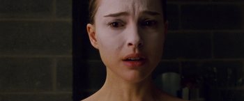 Movie still from “Black Swan” (2010), directed by Darren Aronofsky – A woman's face in a dark room; Close Up shot, High angle