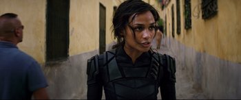 Movie still from “Black Widow” (2021), directed by Cate Shortland – A person wearing a costume; Close Up shot, Over the shoulder angle