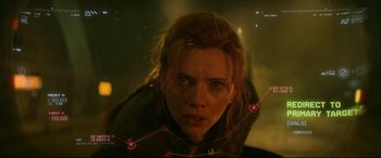 Movie still from “Black Widow” (2021), directed by Cate Shortland – A woman's face in front of an image of a city; Close Up shot, Low angle