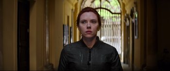 Movie still from “Black Widow” (2021), directed by Cate Shortland – A person wearing a black jacket; Close Up shot, Low angle