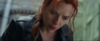 Movie still from “Black Widow” (2021), directed by Cate Shortland – A person with red hair; Close Up shot, Over the shoulder angle