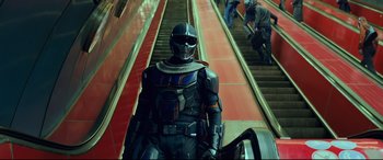 Movie still from “Black Widow” (2021), directed by Cate Shortland – A man riding a train down the side of a set of stairs; Medium shot, Low angle