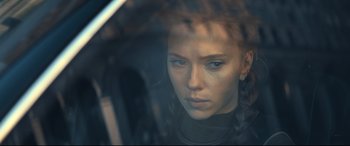 Movie still from “Black Widow” (2021), directed by Cate Shortland – A young woman looking out of a car window; Close Up shot, Over the shoulder angle