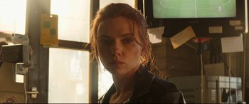 Movie still from “Black Widow” (2021), directed by Cate Shortland – A person wearing a leather jacket; Close Up shot, Low angle