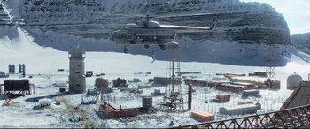 Movie still from “Black Widow” (2021), directed by Cate Shortland – A helicopter is flying over a construction site; Extreme Wide shot, High angle