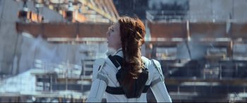 Movie still from “Black Widow” (2021), directed by Cate Shortland – A woman with long red hair wearing a white suit; Medium shot, Low angle