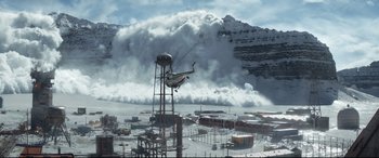 Movie still from “Black Widow” (2021), directed by Cate Shortland – A helicopter flying through the air near a mountain; Extreme Wide shot, High angle