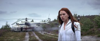 Movie still from “Black Widow” (2021), directed by Cate Shortland – A woman standing in front of an airplane on a field; Medium shot, Low angle