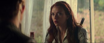 Movie still from “Black Widow” (2021), directed by Cate Shortland – A person with long red hair; Close Up shot, Over the shoulder angle